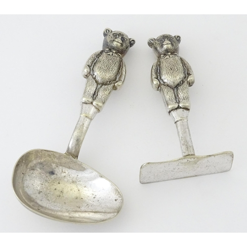 448 - A silver plate child's spoon and pusher with teddy bear detail to handle. Largest approx. 3 3/4