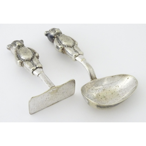 448 - A silver plate child's spoon and pusher with teddy bear detail to handle. Largest approx. 3 3/4