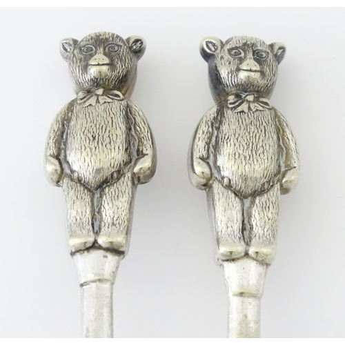 448 - A silver plate child's spoon and pusher with teddy bear detail to handle. Largest approx. 3 3/4