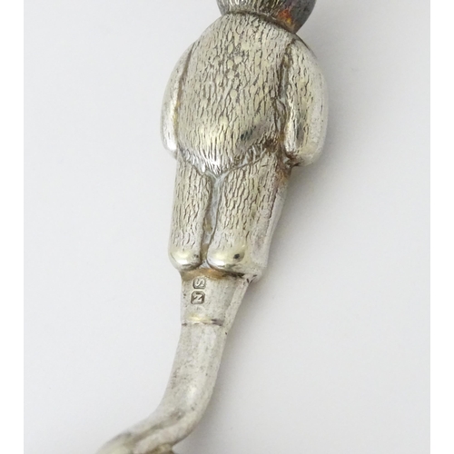 448 - A silver plate child's spoon and pusher with teddy bear detail to handle. Largest approx. 3 3/4