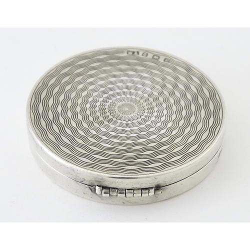 452 - An Art Deco silver compact with engine turned decoration and mirror to lid, hallmarked Birmingham 19... 