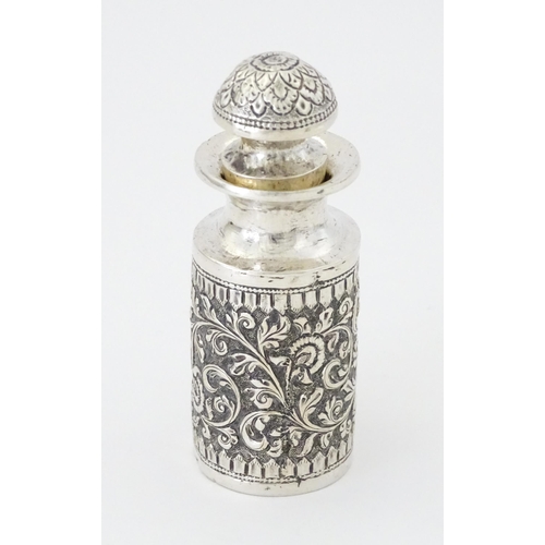 455 - A white metal scent / perfume bottle with acanthus scroll detail. Possibly Indian. Approx. 3 3/4