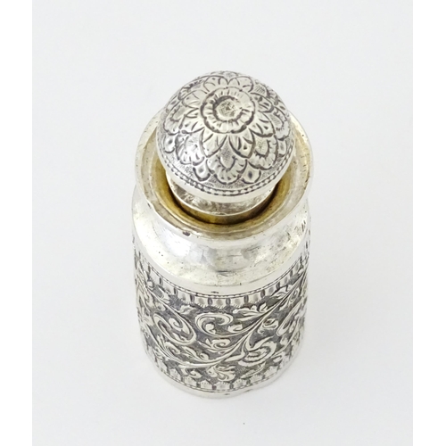 455 - A white metal scent / perfume bottle with acanthus scroll detail. Possibly Indian. Approx. 3 3/4