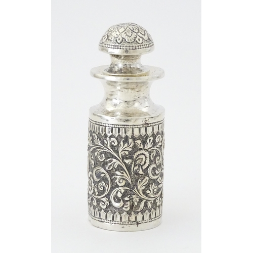 455 - A white metal scent / perfume bottle with acanthus scroll detail. Possibly Indian. Approx. 3 3/4