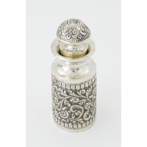 455 - A white metal scent / perfume bottle with acanthus scroll detail. Possibly Indian. Approx. 3 3/4