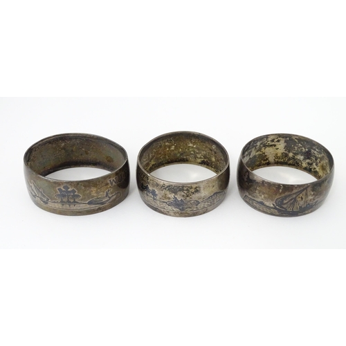 459 - Three white metal napkin rings with niello decoration depicting Egyptian scenes with camels, River N... 