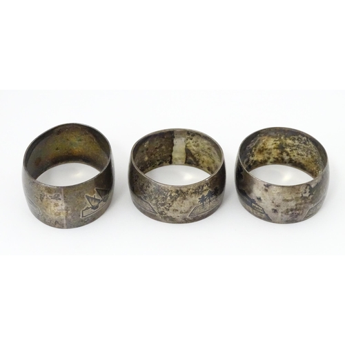 459 - Three white metal napkin rings with niello decoration depicting Egyptian scenes with camels, River N... 