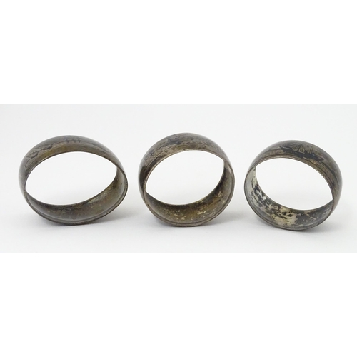 459 - Three white metal napkin rings with niello decoration depicting Egyptian scenes with camels, River N... 