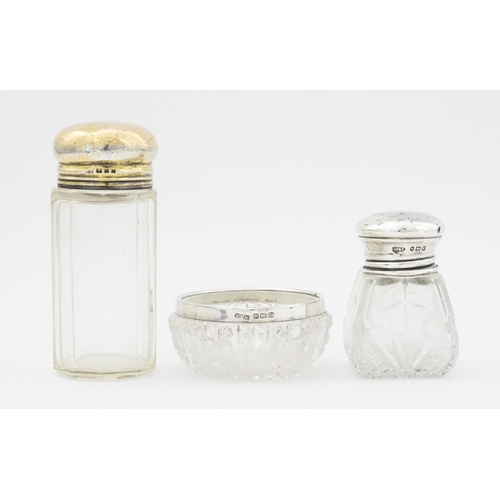 462 - A cut glass salts bottle with silver top hallmarked London 1923, maker Henry Perkins & Sons, a dress... 