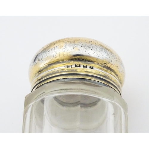 462 - A cut glass salts bottle with silver top hallmarked London 1923, maker Henry Perkins & Sons, a dress... 