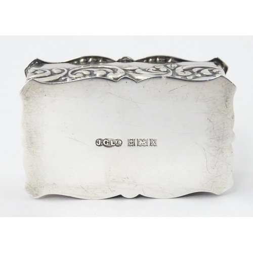 471 - A silver pill box with embossed decoration hallmarked Birmingham 1972, maker Joseph Gloster Ltd. App... 