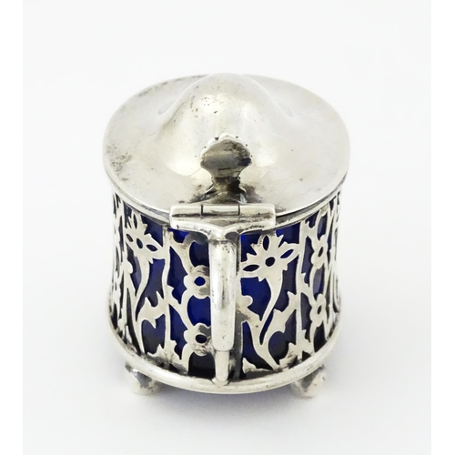 479 - A silver mustard pot of oval form with pierced decoration and blue glass liner, hallmarked Birmingha... 