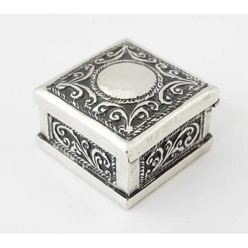 492 - A white metal pill box of squared form with scroll and elephant decoration. Indistinctly marked, pos... 