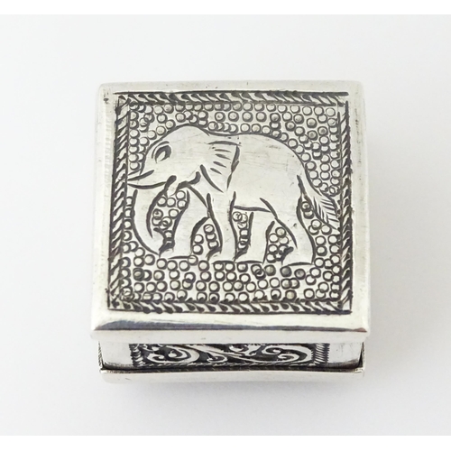 492 - A white metal pill box of squared form with scroll and elephant decoration. Indistinctly marked, pos... 