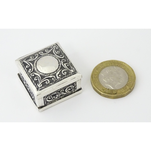 492 - A white metal pill box of squared form with scroll and elephant decoration. Indistinctly marked, pos... 