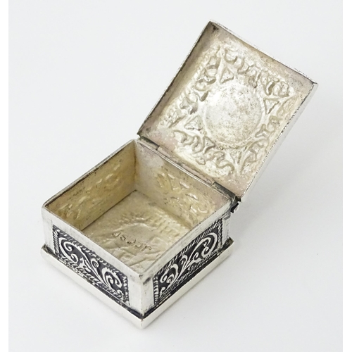 492 - A white metal pill box of squared form with scroll and elephant decoration. Indistinctly marked, pos... 