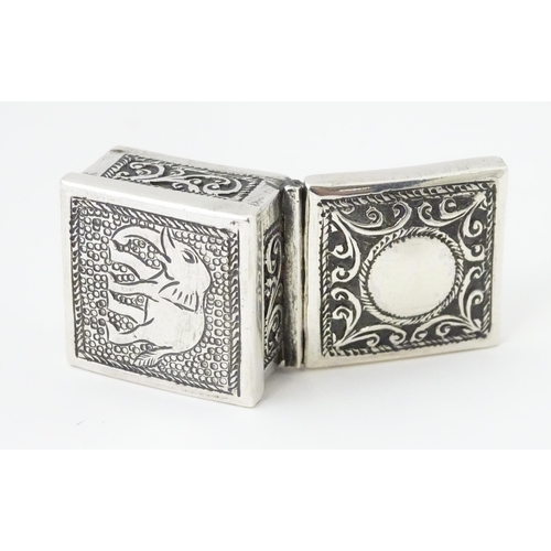 492 - A white metal pill box of squared form with scroll and elephant decoration. Indistinctly marked, pos... 