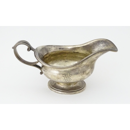 493 - A silver sauce boat hallmarked Sheffield 1912, maker Walker and Hall, and stamped under 1/2 Pint 518... 