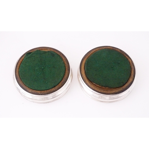 497 - A pair of silver bottle coasters with turned wooden bases, hallmarked London 1978, maker Da-Mar Silv... 