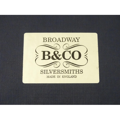 506 - A silver bottle coaster with a turned wooden base hallmarked Birmingham 1994, maker W I Broadway & C... 