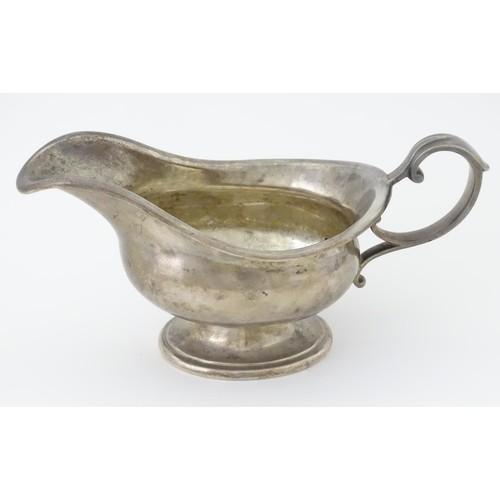 493 - A silver sauce boat hallmarked Sheffield 1912, maker Walker and Hall, and stamped under 1/2 Pint 518... 