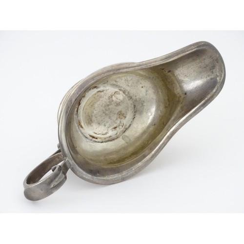 493 - A silver sauce boat hallmarked Sheffield 1912, maker Walker and Hall, and stamped under 1/2 Pint 518... 