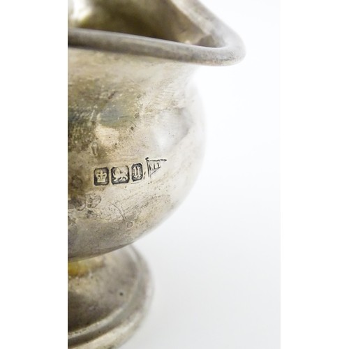 493 - A silver sauce boat hallmarked Sheffield 1912, maker Walker and Hall, and stamped under 1/2 Pint 518... 