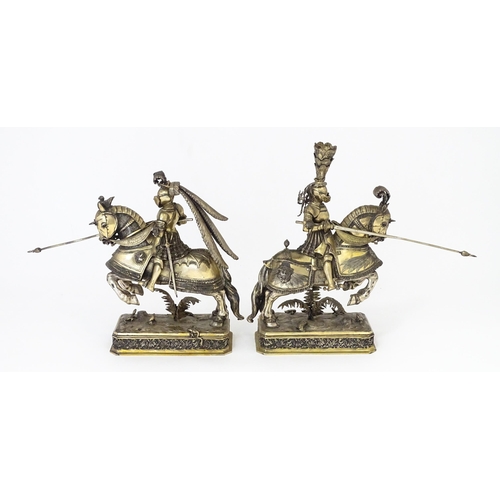 369 - A pair of silver gilt jousting knights on horseback, bearing marks probably for Neresheimer, Hanau, ... 