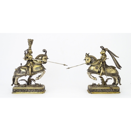 369 - A pair of silver gilt jousting knights on horseback, bearing marks probably for Neresheimer, Hanau, ... 