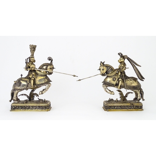 369 - A pair of silver gilt jousting knights on horseback, bearing marks probably for Neresheimer, Hanau, ... 