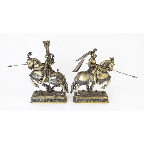 369 - A pair of silver gilt jousting knights on horseback, bearing marks probably for Neresheimer, Hanau, ... 