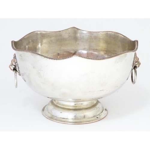 589 - A Large silver plate pedestal punch bowl with lion mask handles, together with a silver plate punch ... 