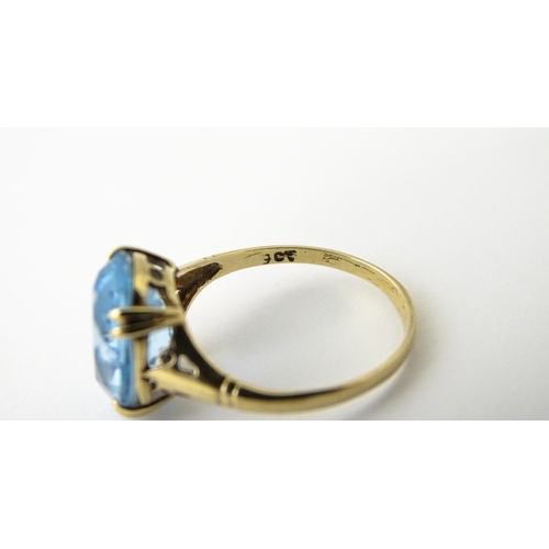 604 - A 9ct gold ring set with aquamarine. Ring size approx. N 1/2