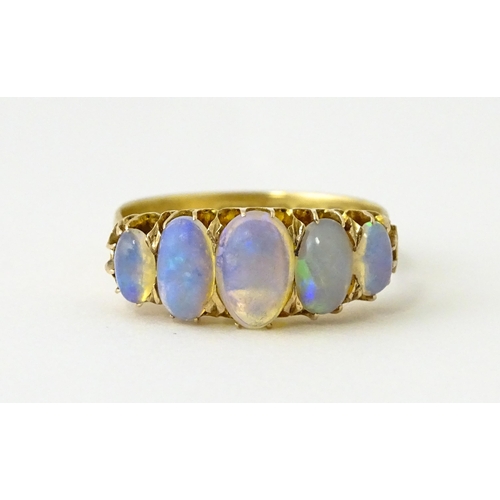 608 - A Victorian 18ct gold ring set with five graduated opals. Ring size approx. O