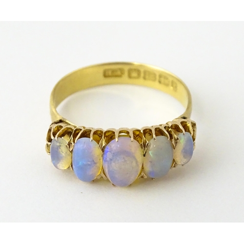 608 - A Victorian 18ct gold ring set with five graduated opals. Ring size approx. O