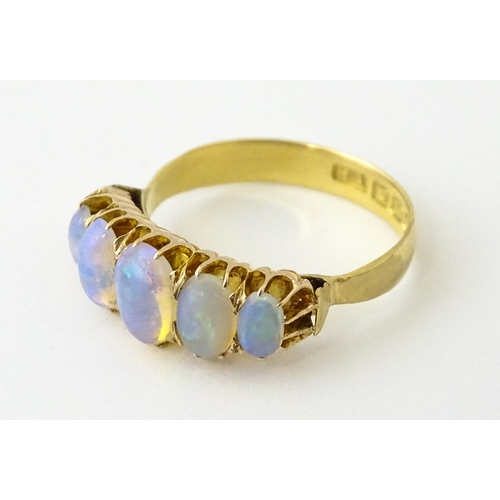 608 - A Victorian 18ct gold ring set with five graduated opals. Ring size approx. O