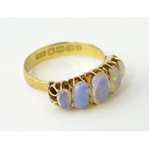 608 - A Victorian 18ct gold ring set with five graduated opals. Ring size approx. O