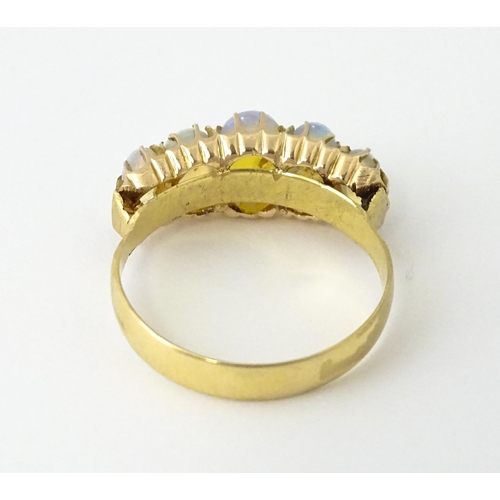 608 - A Victorian 18ct gold ring set with five graduated opals. Ring size approx. O