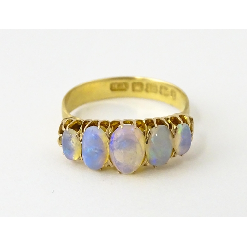 608 - A Victorian 18ct gold ring set with five graduated opals. Ring size approx. O