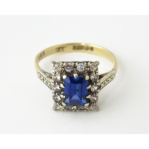 612 - A 9ct gold ring set with central sapphire bordered by white stones.  Ring size approx. M