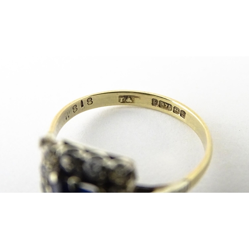 612 - A 9ct gold ring set with central sapphire bordered by white stones.  Ring size approx. M