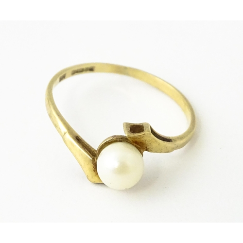 614 - A 9ct gold ring set with central pearl. Ring size approx. S 1/2