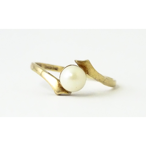 614 - A 9ct gold ring set with central pearl. Ring size approx. S 1/2