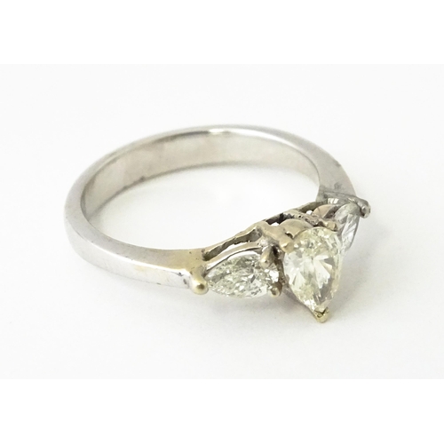 615 - A white gold ring set with central diamonds flanked by diamonds. Ring size approx. J