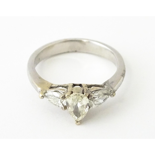 615 - A white gold ring set with central diamonds flanked by diamonds. Ring size approx. J