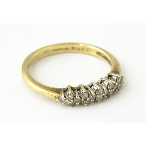 617 - A 9ct gold ring set with 16 diamonds. Ring size approx. K