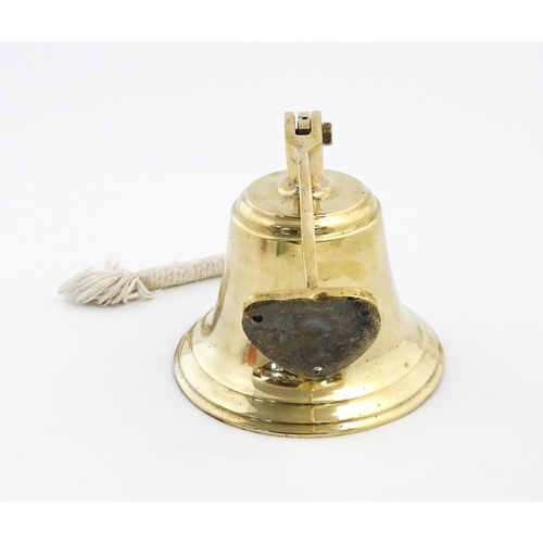 1087 - Nautical / Maritime Interest: A 20thC brass wall mounting ships bell. Approx. 6 1/2