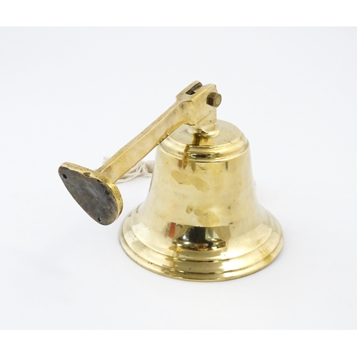 1087 - Nautical / Maritime Interest: A 20thC brass wall mounting ships bell. Approx. 6 1/2