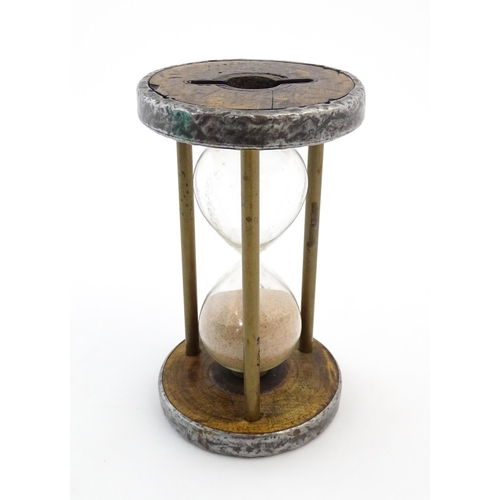 1111 - An early 20thC sand / egg timer with metal mounts. Approx. 6 1/4