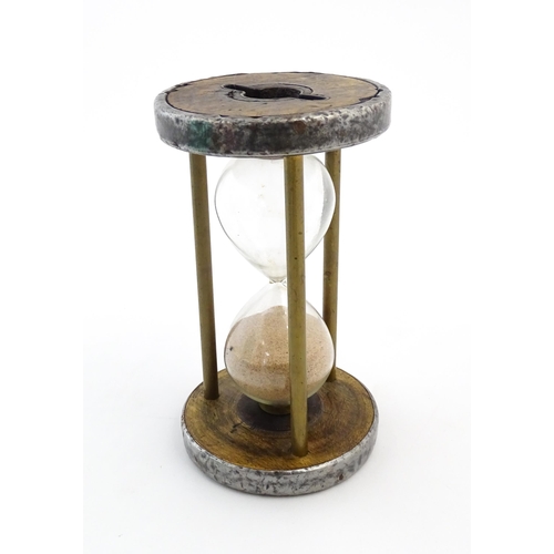 1111 - An early 20thC sand / egg timer with metal mounts. Approx. 6 1/4